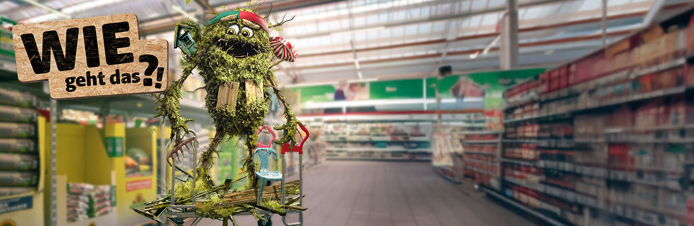Ein Gartenmonsterchen auf einem Einkaufswagen im Baumarkt